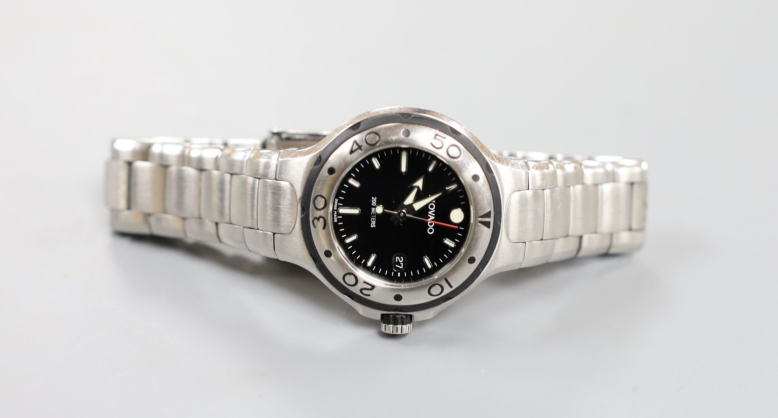 A lady's modern stainless steel Movado quartz wrist watch, on a stainless steel Movado bracelet, with box.